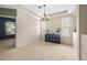 Bright, carpeted dining area with natural light, featuring a modern light fixture and beige walls at 18243 Cypress Bay Pkwy, Land O Lakes, FL 34638