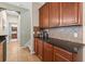 Hallway with stylish cabinets, granite countertops, and a seamless transition to other areas of the home at 18243 Cypress Bay Pkwy, Land O Lakes, FL 34638