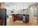 Open concept kitchen with granite countertops, stainless steel appliances, and seamless flow to the living area at 18243 Cypress Bay Pkwy, Land O Lakes, FL 34638