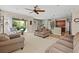 Spacious living area featuring comfortable seating, a ceiling fan, and a view of the outdoor patio at 18243 Cypress Bay Pkwy, Land O Lakes, FL 34638