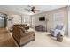 Bright living room with neutral carpet, comfortable seating, and an open layout, perfect for relaxing and entertaining at 18243 Cypress Bay Pkwy, Land O Lakes, FL 34638