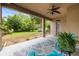 Covered patio with ceiling fan and outdoor seating overlooking the backyard at 18243 Cypress Bay Pkwy, Land O Lakes, FL 34638