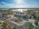 Aerial view of a three-story multifamily home with a black roof and white siding near a body of water and other homes at 187 145Th E Ave # 3, Madeira Beach, FL 33708