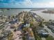 Beautiful aerial view of a waterfront neighborhood with a modern condo building featuring balconies and ample parking at 187 145Th E Ave # 3, Madeira Beach, FL 33708