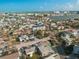 Stunning aerial view of neighborhood with waterfront access and beautiful blue skies, and a condominium building in the center at 187 145Th E Ave # 3, Madeira Beach, FL 33708