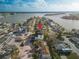 Beautiful aerial view of a waterfront neighborhood with a modern condo building featuring balconies and ample parking at 187 145Th E Ave # 3, Madeira Beach, FL 33708