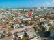 Stunning aerial view of neighborhood with waterfront access and beautiful blue skies, and a condominium building in the center at 187 145Th E Ave # 3, Madeira Beach, FL 33708