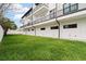 Exterior of townhouses with a well maintained grass yard and black metal balconies at 187 145Th E Ave # 3, Madeira Beach, FL 33708