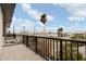 Balcony view showcasing palm trees and cityscape under a bright blue sky at 187 145Th E Ave # 3, Madeira Beach, FL 33708