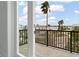Balcony showcasing a view of the neighborhood and surrounding landscape with a black metal railing at 187 145Th E Ave # 3, Madeira Beach, FL 33708