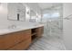 Elegant bathroom with dual sinks, modern vanity, and a luxurious marble shower at 187 145Th E Ave # 3, Madeira Beach, FL 33708