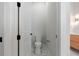 Bathroom features white toilet, black hardware, and a glimpse of a modern vanity at 187 145Th E Ave # 3, Madeira Beach, FL 33708