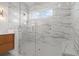 Modern bathroom with marble-lined glass shower enclosure and stylish fixtures at 187 145Th E Ave # 3, Madeira Beach, FL 33708