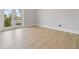 Bright bedroom featuring light-colored wood floors and glass doors leading to a balcony at 187 145Th E Ave # 3, Madeira Beach, FL 33708