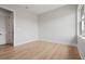A bright, empty bedroom with light-colored floors, featuring a window and door at 187 145Th E Ave # 3, Madeira Beach, FL 33708
