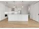 Spacious kitchen features an island, stainless steel refrigerator, and modern pendant lighting at 187 145Th E Ave # 3, Madeira Beach, FL 33708