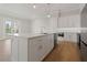 Bright kitchen with a large island, white cabinets, and stainless steel appliances at 187 145Th E Ave # 3, Madeira Beach, FL 33708