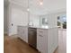 Bright kitchen with a center island, stainless steel appliances, and wood flooring at 187 145Th E Ave # 3, Madeira Beach, FL 33708