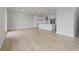 Open-concept living room and kitchen with light wood floors and recessed lighting at 187 145Th E Ave # 3, Madeira Beach, FL 33708