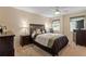 Comfortable bedroom with a ceiling fan, carpeted floor, and a large window at 19029 Us Highway 19 N # 26-204, Clearwater, FL 33764