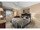 Cozy bedroom with ceiling fan, seascape art and ample natural light at 19029 Us Highway 19 N # 26-204, Clearwater, FL 33764
