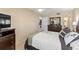 Cozy bedroom features carpeted floors, ceiling fan, large bed, and storage dresser at 19029 Us Highway 19 N # 26-204, Clearwater, FL 33764