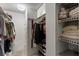 Walk-in closet with shelves, storage, and hanging space for organized wardrobe at 19029 Us Highway 19 N # 26-204, Clearwater, FL 33764