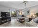 Relax in this living room with tiled floor, ceiling fan, slider and comfortable furnishings at 19029 Us Highway 19 N # 26-204, Clearwater, FL 33764