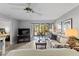 Bright living room with tiled floor, ceiling fan and sliding glass doors to the balcony at 19029 Us Highway 19 N # 26-204, Clearwater, FL 33764