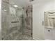 Updated bathroom featuring a shower with glass door and decorative tile at 19029 Us Highway 19 N # 26-204, Clearwater, FL 33764