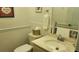 Bathroom featuring a toilet, single sink vanity, framed art and towel rack with towel at 19029 Us Highway 19 N # 8-13, Clearwater, FL 33764