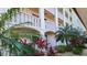 Exterior of a building with white columns and tropical plants at 19029 Us Highway 19 N # 8-13, Clearwater, FL 33764