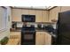 Well-lit kitchen featuring modern appliances, light wood cabinets, and complementary countertops at 19029 Us Highway 19 N # 8-13, Clearwater, FL 33764