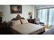 Comfortable main bedroom with a decorative headboard, side tables, and relaxing sitting chair at 19029 Us Highway 19 N # 8-13, Clearwater, FL 33764