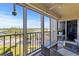 Relaxing screened-in balcony with seating area offers stunning views of the surrounding landscape at 19029 Us Highway 19 N # 9-407, Clearwater, FL 33764