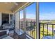 Relaxing screened-in balcony with seating area offers stunning views of the neighborhood at 19029 Us Highway 19 N # 9-407, Clearwater, FL 33764