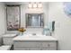 Bathroom featuring a large mirror, a vanity with drawers, a bouquet, and updated fixtures at 19029 Us Highway 19 N # 9-407, Clearwater, FL 33764