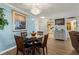 Cozy dining area featuring a modern chandelier and a round table for four at 19029 Us Highway 19 N # 9-407, Clearwater, FL 33764