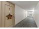 Hallway view leading to Unit 407 adorned with a star decoration on the door at 19029 Us Highway 19 N # 9-407, Clearwater, FL 33764