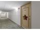 Hallway view leading to Unit 407 adorned with a star decoration on the door at 19029 Us Highway 19 N # 9-407, Clearwater, FL 33764