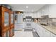 Bright kitchen with white cabinets, granite countertops, and modern appliances at 19029 Us Highway 19 N # 9-407, Clearwater, FL 33764