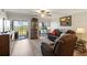 Comfortable living room with hardwood floors, ceiling fan, slider doors, and comfortable seating at 19029 Us Highway 19 N # 9-407, Clearwater, FL 33764