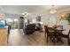 Open living room with hardwood floors, ceiling fan, slider doors, and comfortable seating at 19029 Us Highway 19 N # 9-407, Clearwater, FL 33764