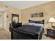 Comfortable bedroom with stylish, dark wood furniture and neutral walls at 1910 E Palm Ave # 11216, Tampa, FL 33605