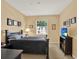 Bright bedroom featuring a window and a TV on a sleek bookshelf at 1910 E Palm Ave # 11216, Tampa, FL 33605