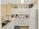 Well-lit kitchen featuring white appliances, ample counter space, and modern fixtures at 1910 E Palm Ave # 11216, Tampa, FL 33605