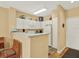 Clean kitchen with white appliances, plenty of counter space, and an adjacent dining area at 1910 E Palm Ave # 11216, Tampa, FL 33605