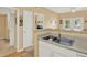 Kitchen sink with breakfast bar, open to the dining area with a bedroom view in the background at 1910 E Palm Ave # 11216, Tampa, FL 33605