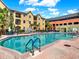 Outdoor pool area with blue water, patio, and lounge area set against a beautiful blue sky at 1910 E Palm Ave # 11216, Tampa, FL 33605