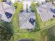 Aerial view showcasing a home with solar panels, manicured lawn, driveway, and a view of the surrounding neighborhood at 19325 Hawk Valley Dr, Tampa, FL 33647
